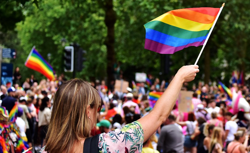 Women waving rainbow flag at Bristol Pride march